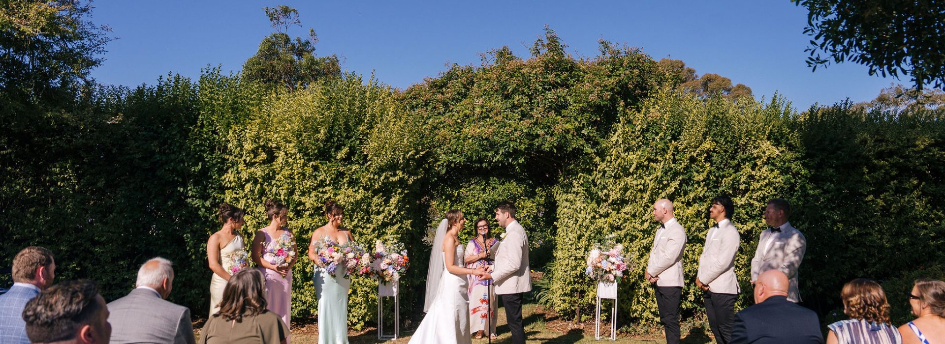 A beautiful rustic wedding ceremony at an event venue in Melbourne, adorned with wisteria flowers.